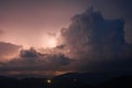 Evening thunderstorm with lightning in the mountains. Dramatic clouds during a thunderstorm pierce the light of Royalty Free Stock Photo