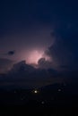 Evening thunderstorm with lightning in the mountains. Dramatic clouds during a thunderstorm pierce the light of Royalty Free Stock Photo