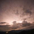 Evening thunderstorm with lightning in the mountains. Dramatic clouds during a thunderstorm pierce the light of Royalty Free Stock Photo