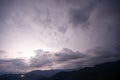 Evening thunderstorm with lightning in the mountains. Dramatic clouds during a thunderstorm pierce the light of Royalty Free Stock Photo