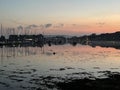 The evening tide retreating over a sunset sky