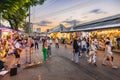 Evening time At Chatuchak Market, witness young performers and street musicians showcasing diverse talents through busking and