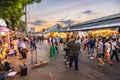 Evening time At Chatuchak Market, witness young performers and street musicians showcasing diverse talents through busking and