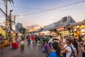 Evening time At Chatuchak Market, witness young performers and street musicians showcasing diverse talents through busking and