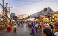 Evening time At Chatuchak Market, witness young performers and street musicians showcasing diverse talents through busking and
