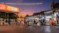 Evening time At Chatuchak Market, witness young performers and street musicians showcasing diverse talents through busking and