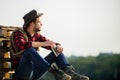 Evening time. Farmer drink alcohol enjoy view from his farm. Watching sunset. Farmer cowboy handsome man relaxing after Royalty Free Stock Photo