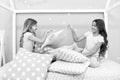 Evening time for fun. Sleepover party ideas. Girls happy best friends or siblings in cute stylish pajamas with pillows Royalty Free Stock Photo