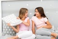 Evening time for fun. Sleepover party ideas. Girls happy best friends or siblings in cute stylish pajamas with pillows Royalty Free Stock Photo