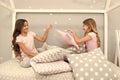 Evening time for fun. Sleepover party ideas. Girls happy best friends or siblings in cute stylish pajamas with pillows Royalty Free Stock Photo