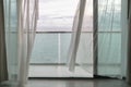 Evening time of ocean view from hotel balcony with curtains. Royalty Free Stock Photo