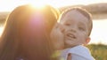 At the evening time before the sunset, baby feeling happy and smiles with her mother in the garden Royalty Free Stock Photo