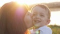 At the evening time before the sunset, baby feeling happy and smiles with her mother in the garden Royalty Free Stock Photo