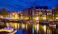 Evening town Amsterdam in Netherlands on bank river canal Royalty Free Stock Photo