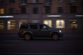Evening traffic on the city streets. Black Nissan Pathfinder R51 SUV car driving in night urban road Royalty Free Stock Photo