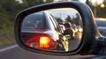 Evening traffic jam rearview mirror shows cars with headlights queuing in a long line