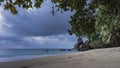 Evening on a tropical beach. The waves of the turquoise ocean are foaming. Royalty Free Stock Photo