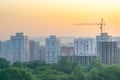 Evening urban landscape of a residential area under construction with a construction crane Royalty Free Stock Photo