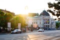 Evening Vienna street, view of the Volkstheater and the road with passing cars.