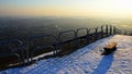 Evening view on cityscape from viewpoint hill with steel rail and old bench during snowy season. Location Nitra city, Slovakia