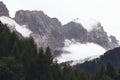 Evening view of the Dolomites covered with heavy fog after rain