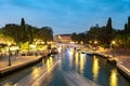 Evening view of illuminated old buildings, bridges, floating boats and light reflections in canals water in Venice, Italy Royalty Free Stock Photo