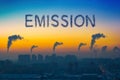 Evening view of the industrial landscape of the city with smoke emissions from chimneys at sunset. Royalty Free Stock Photo