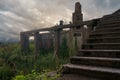 Evening view of an old abandoned wrecked house in the field overgrown with green ivy Royalty Free Stock Photo