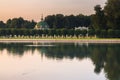 Evening view through the palace pond on the park pavilion `Grotto` in museum-estate Kuskovo, Moscow. Royalty Free Stock Photo