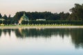 Evening view through the palace pond on the park pavilion `Grotto` in museum-estate Kuskovo, Moscow. Royalty Free Stock Photo