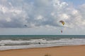 Evening view on small sand dune with green grass. Sandy beach at sea coast. Blue sky with white clouds. Sunset time