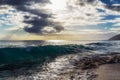 Evening view with sun shining throug clouds at Makua beach, Oahu