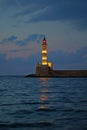 Evening view after sunset of the lighthouse at the entrance of the port of Xania Royalty Free Stock Photo