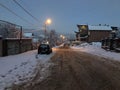 Evening view of the town, snow on the road. Trees in the snow. Mountain ski resort Bakuriani