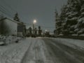 Evening view of the town, snow on the road. Trees in the snow. Mountain ski resort Bakuriani