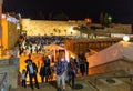 Evening view of Western Wall Plaza square beside Holy Temple Mount with Judaist pilgrims and praying Jews in historic Old City of Royalty Free Stock Photo