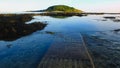 Bright evening sunshine, still, calm waters, rock pools and reef, in Looe Bay, Cornwall UK Royalty Free Stock Photo