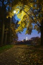 Evening walk in the autumn park illuminated by lanterns at dusk Royalty Free Stock Photo