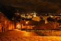 Evening walk in empty city of Prague,Czech Republic.Illuminated Old Stairs from Prague Castle to Lesser Town.Night city lights. Royalty Free Stock Photo