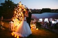 Evening wedding ceremony. The bride and Groom are on the background of the wedding arch. Royalty Free Stock Photo