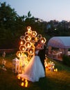 Evening wedding ceremony. The bride and Groom are on the background of the wedding arch. Royalty Free Stock Photo