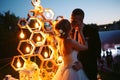 Evening wedding ceremony. The bride and Groom are on the background of the wedding arch. Royalty Free Stock Photo