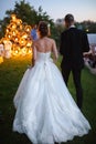 Evening wedding ceremony. The bride and Groom are on the background of the wedding arch. Royalty Free Stock Photo