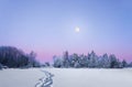 Evening winter landscape with full moon
