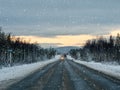 Evening winter snow road on the Kola peninsula. Traffic of cars