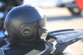 Black closed helmet on the motorcycle seat. Right view close up Royalty Free Stock Photo