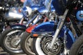 Motorcycles stand in a row on a bright sunny day. Close-up Royalty Free Stock Photo
