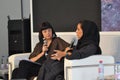 Event moderator interviewing Arabic Designer - Black and white stage and clothing