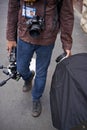 Event photographer en route to a shoot. Cropped image of a young man walking with his photographic equipment. Royalty Free Stock Photo