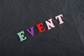 EVENT word on black board background composed from colorful abc alphabet block wooden letters, copy space for ad text